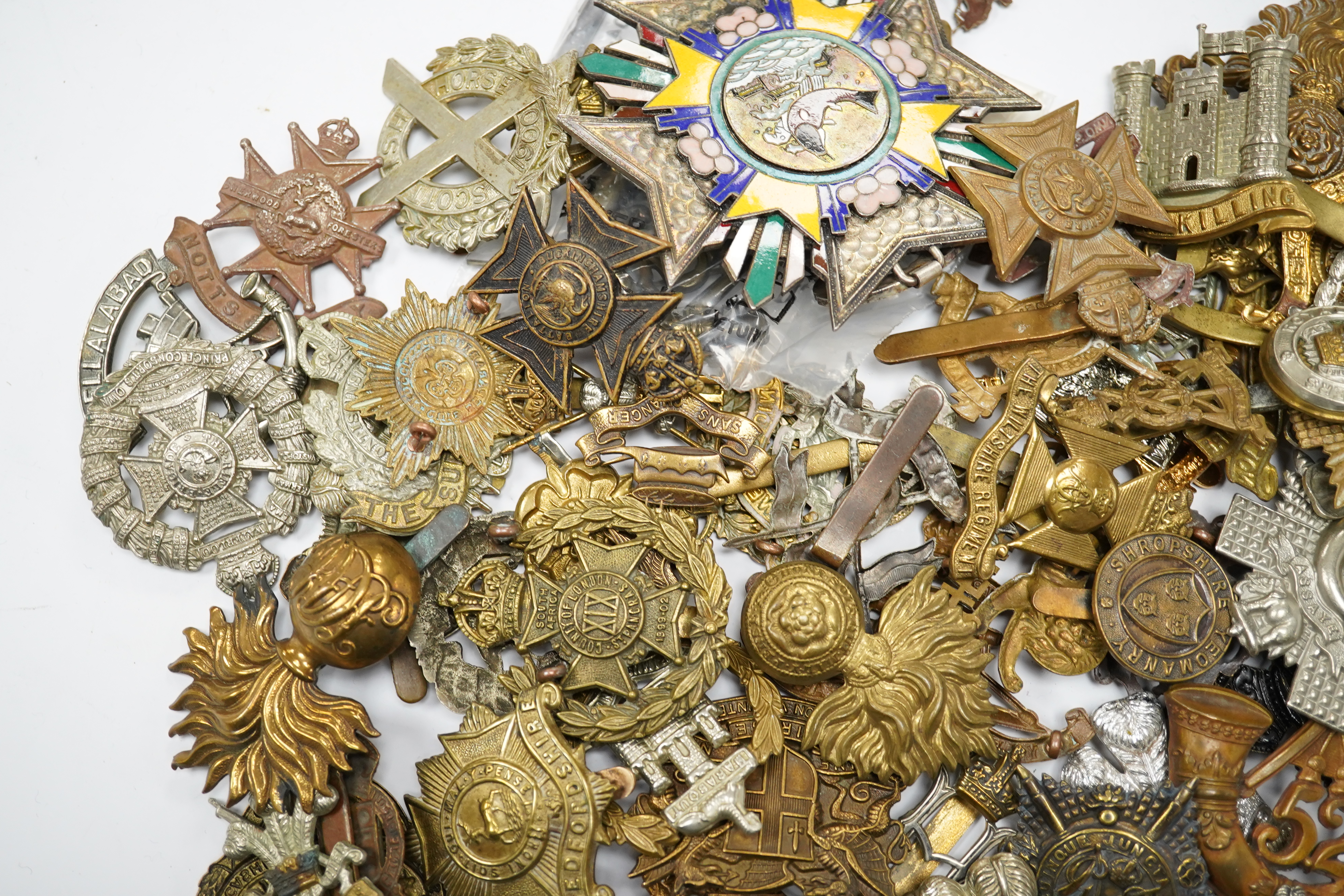 Seventy-eight military cap badges, including; the Royal Horse Artillery, the King’s Own, the Notts and Derby Regiment, the Royal Hussars, the Shropshire Yeomanry, the Herefordshire Regiment, the City of London Volunteer